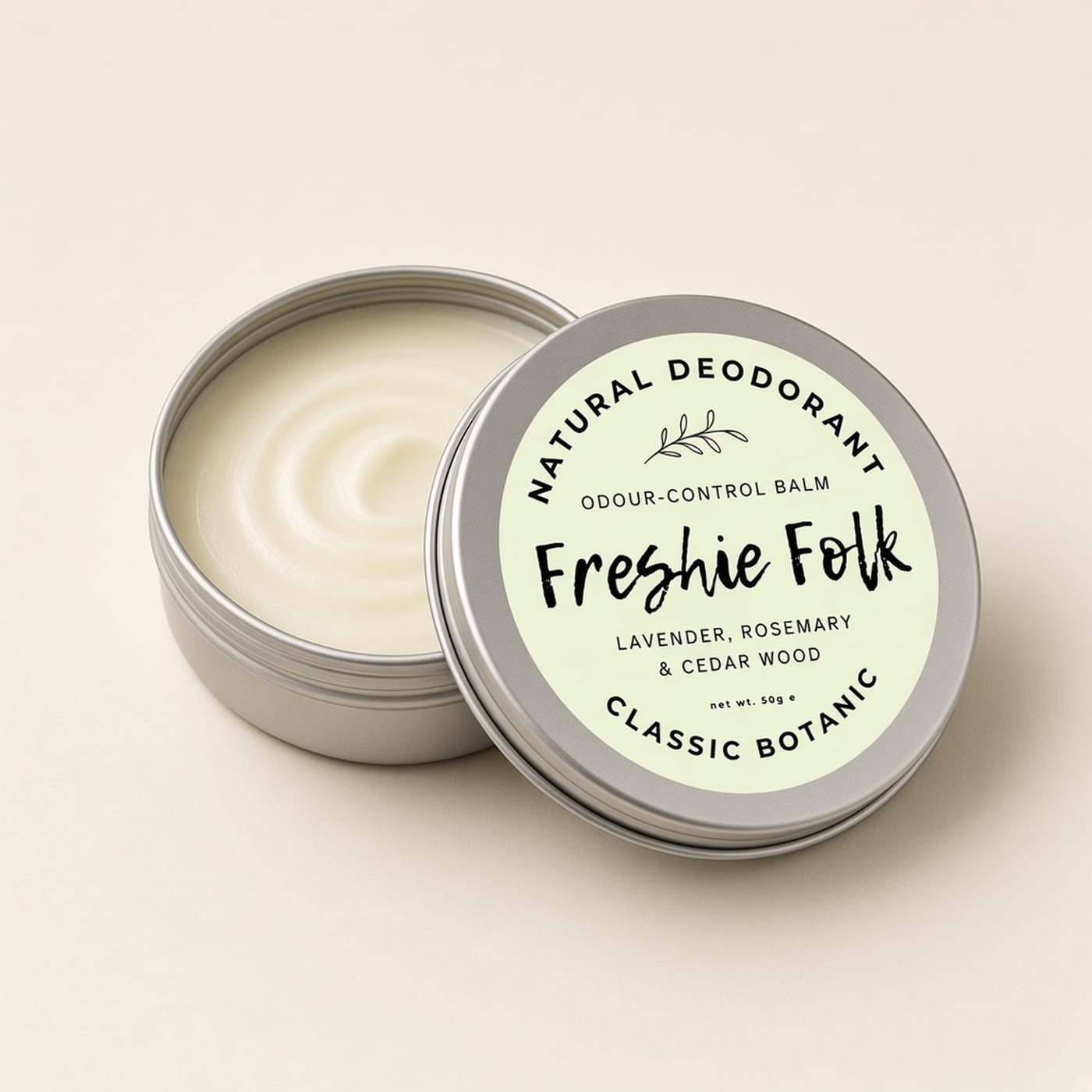 Closed silver tin of Classic Botanic deodorant on a warm off-white background.