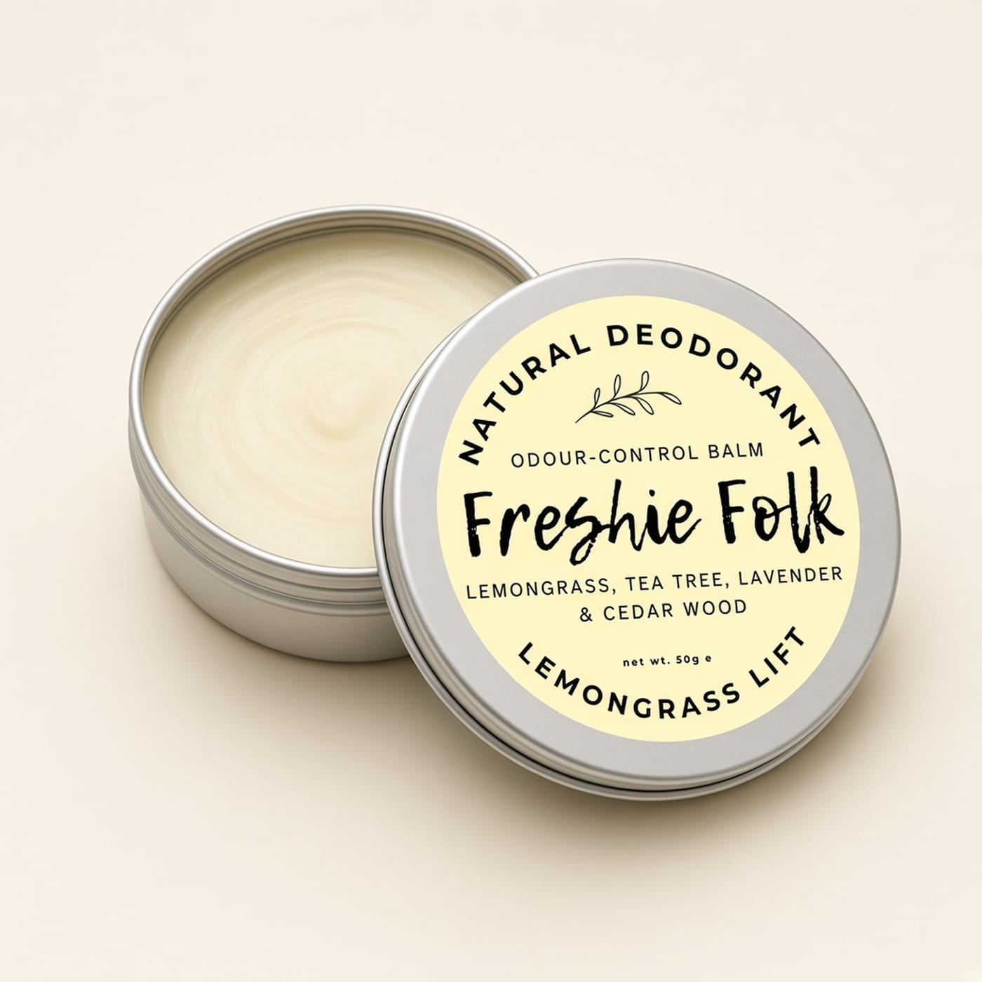 Closed silver tin of Lemongrass Lift deodorant on a warm off-white background.