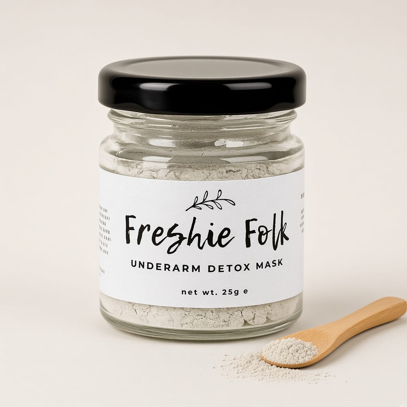 Open jar of the Freshie Folk underarm clay mask on a warm off-white background.